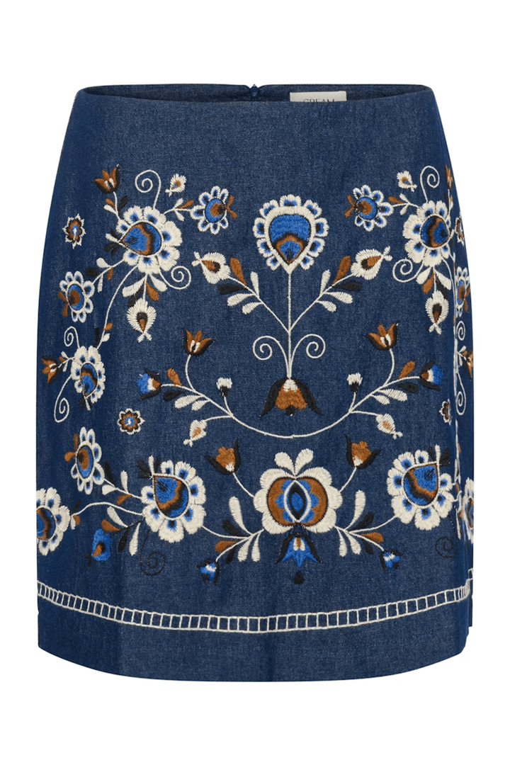 Jupe Gro en denim avec broderies florales contrastées, coupe droite bohème chic petit déjeuner au-dessus du genou.