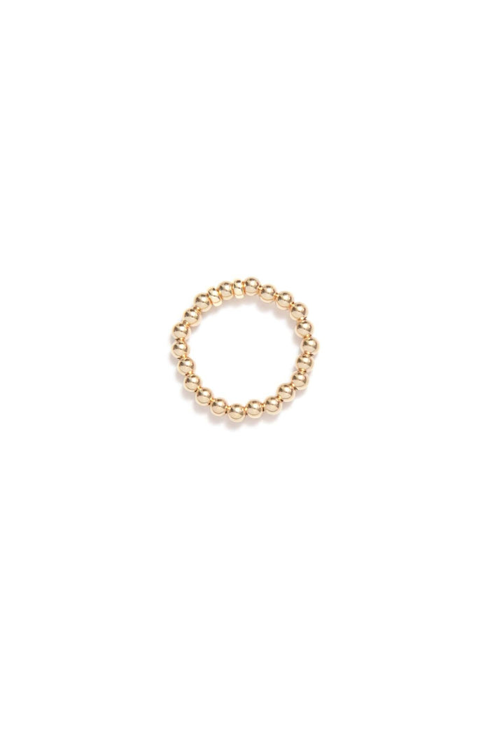 Bague élastique Be Timeless en or avec petites perles dorées, idéale pour un look raffiné et personnalisable.