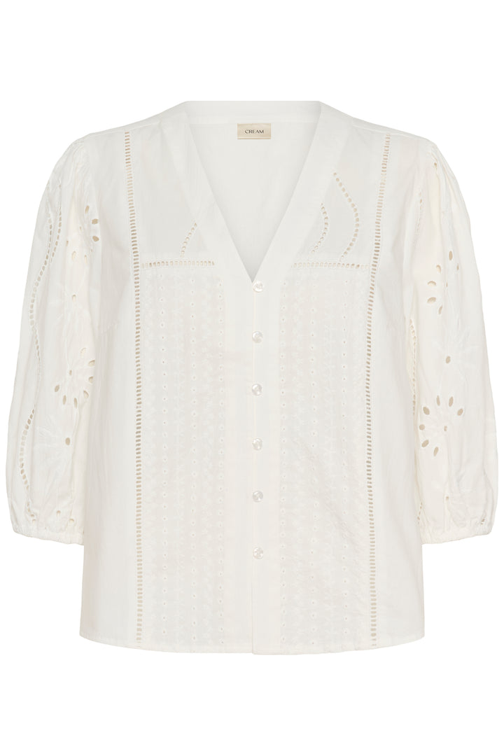 Blouse Signe avec détails ajourés, broderies élégantes et encolure en V, féminine et sophistiquée.