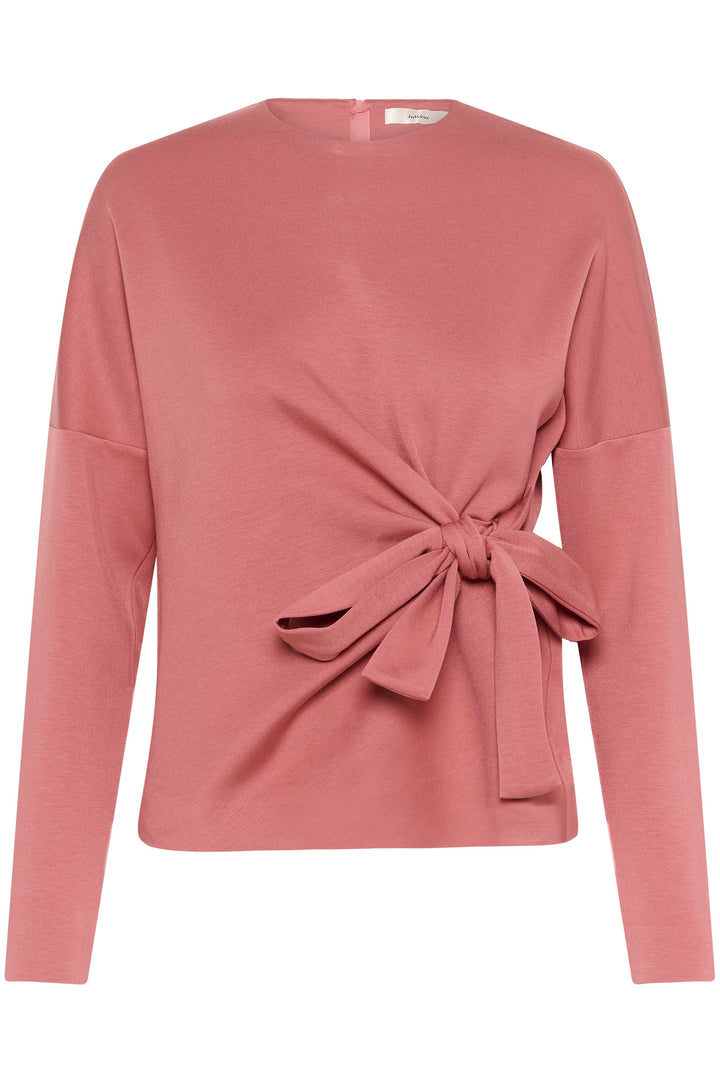 Blouse Tricent rose avec design noué sur le côté, manches longues et encolure arrondie, élégante et confortable.