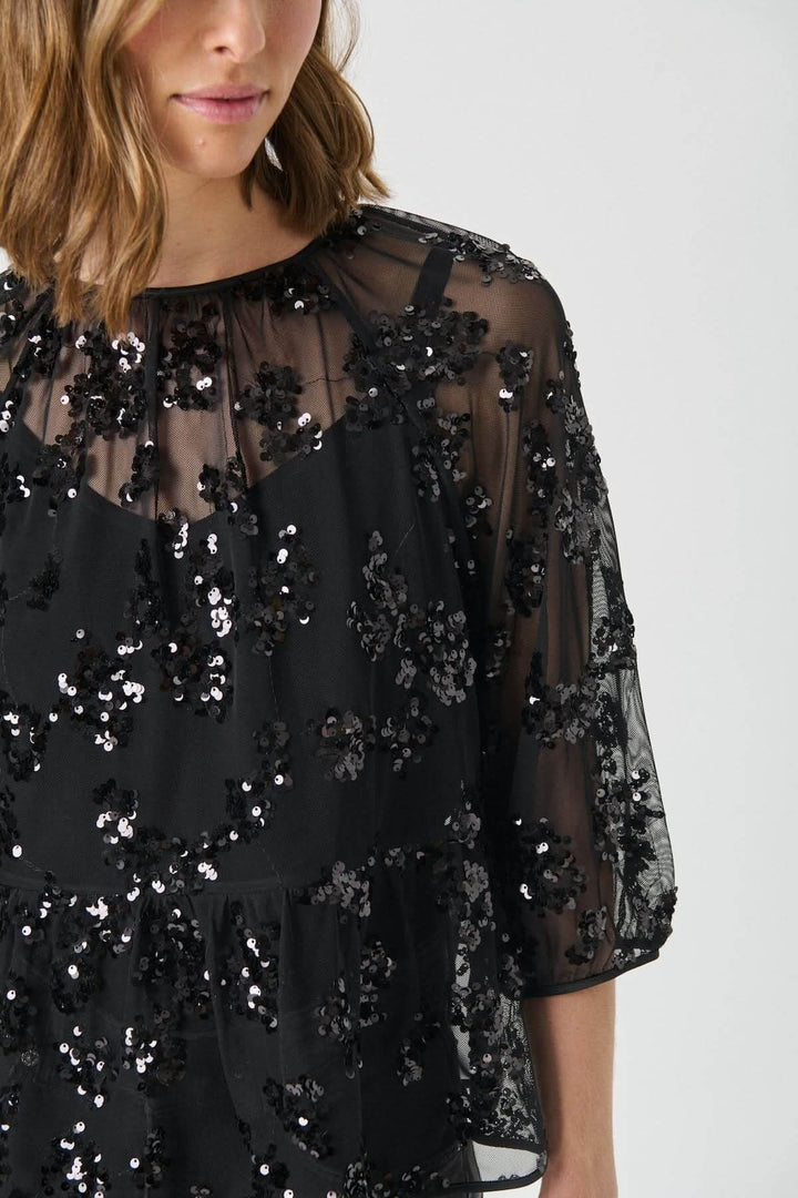 Blouse Vivan à sequins floraux, tulle transparent avec fleurs brodées pour une allure élégante et chic, manches trois-quarts.