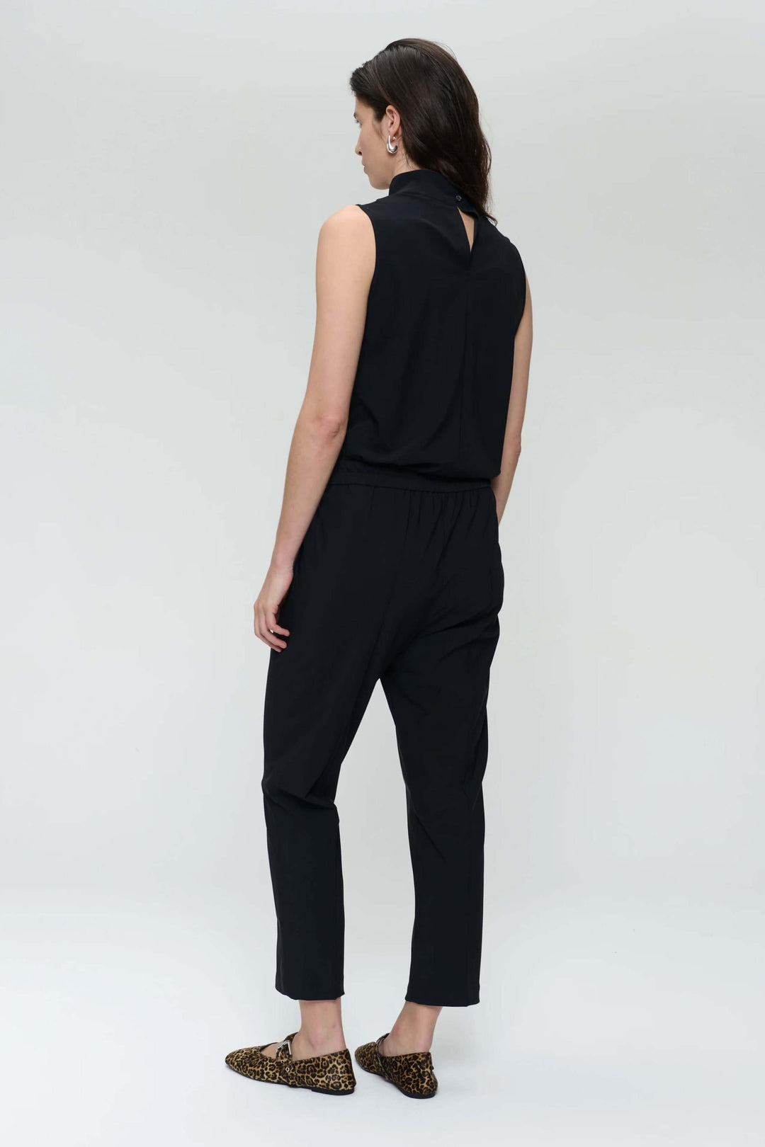 Camisole Naomi sans manches noire avec col drapé asymétrique et ouverture à l’arrière, moderne et élégante.
