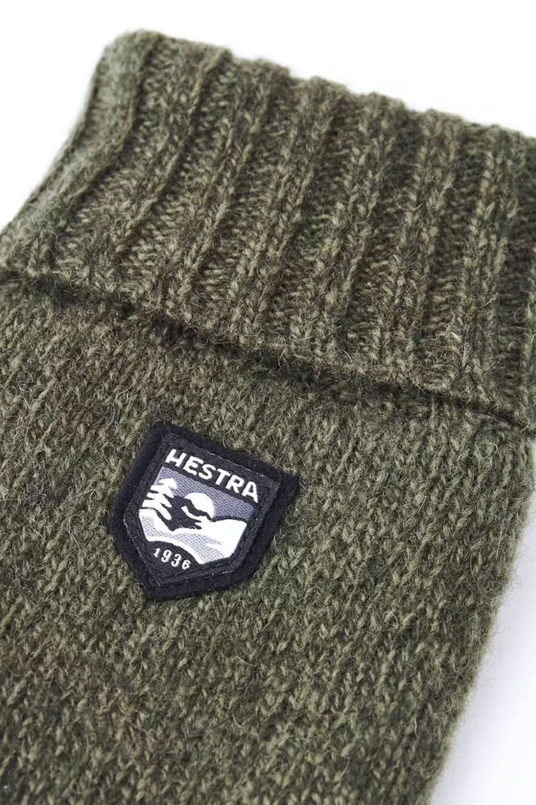 Gant en laine vert avec logo Hestra, tricoté, idéal pour l'isolation et la chaleur.
