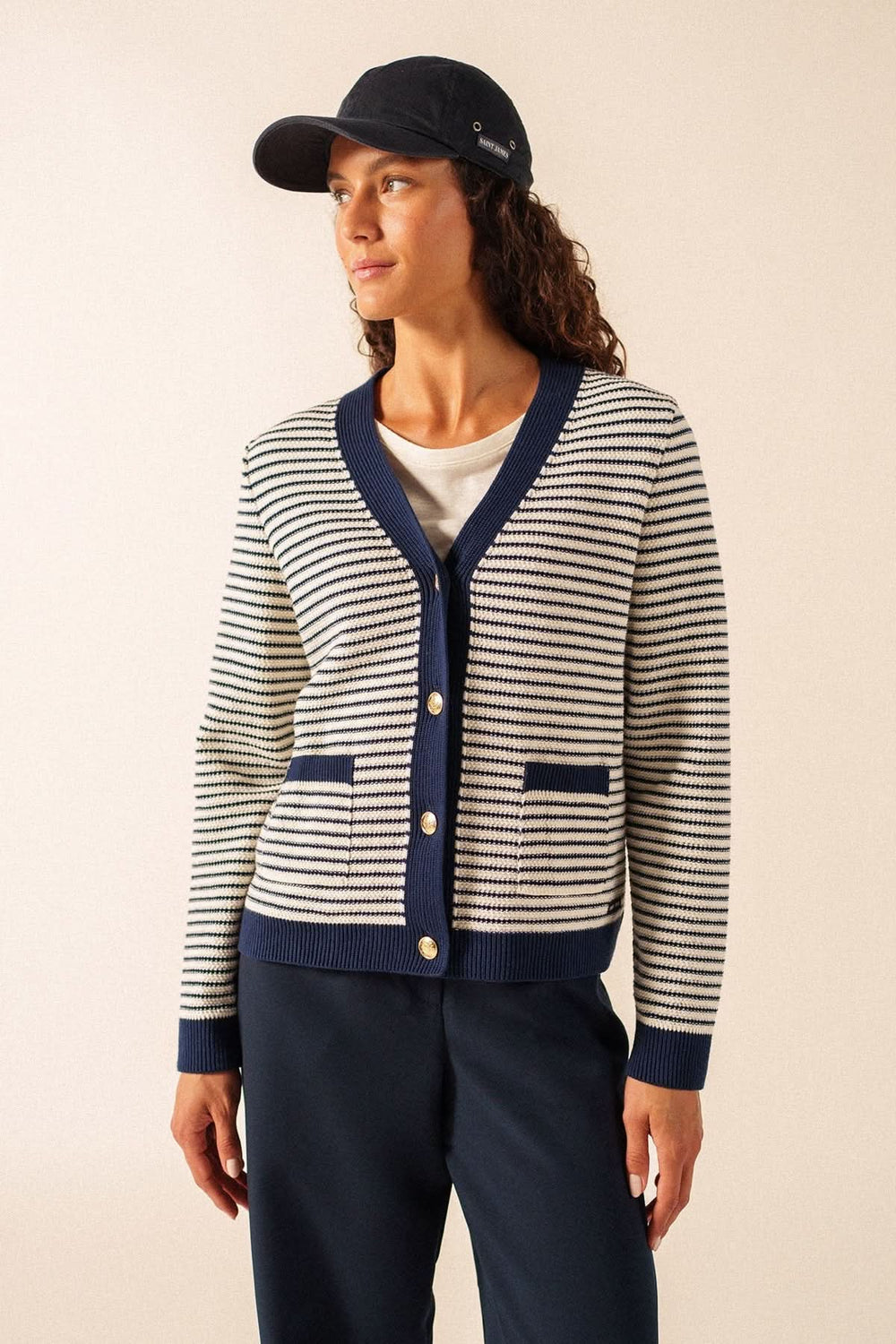 Alt Tag: Femme portant un Cardigan rayé style marin ISTRES, avec encolure en V et patte de boutonnage contrastante.
