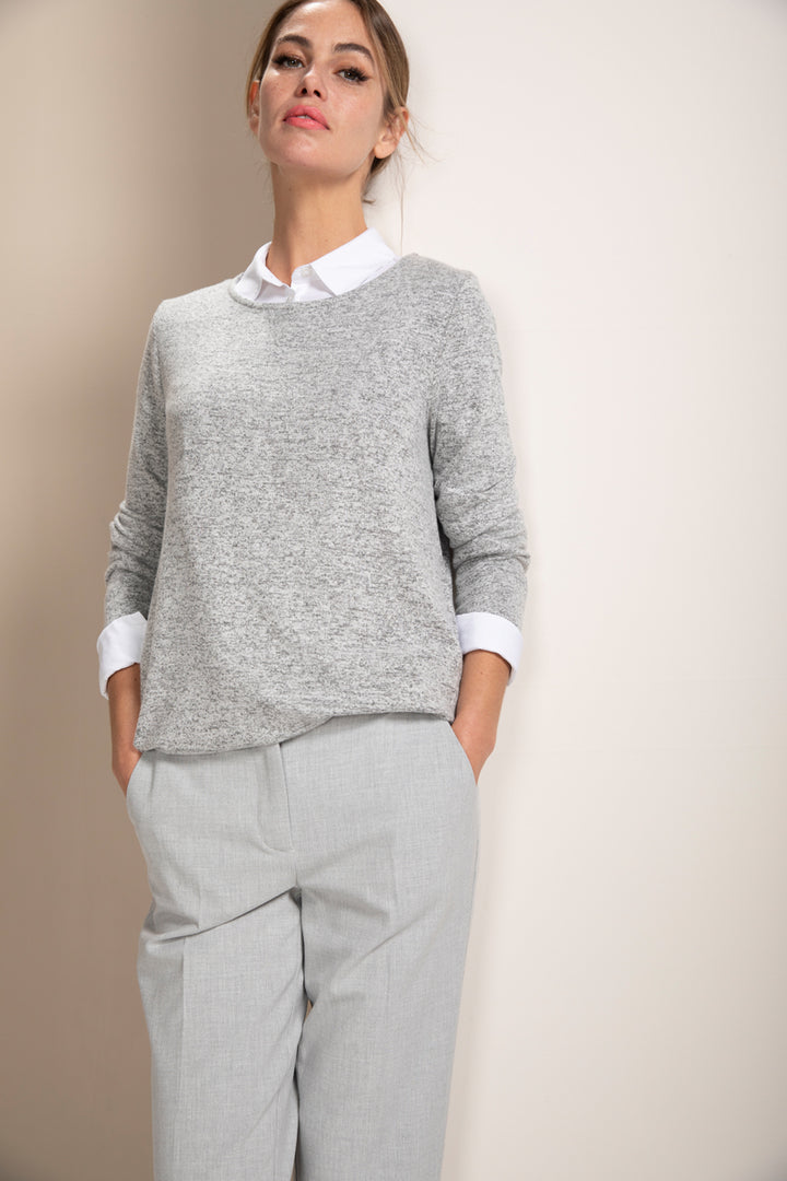 Femme portant un chandail en maille douce, coupe ample, encolure ronde, avec pantalon décontracté.