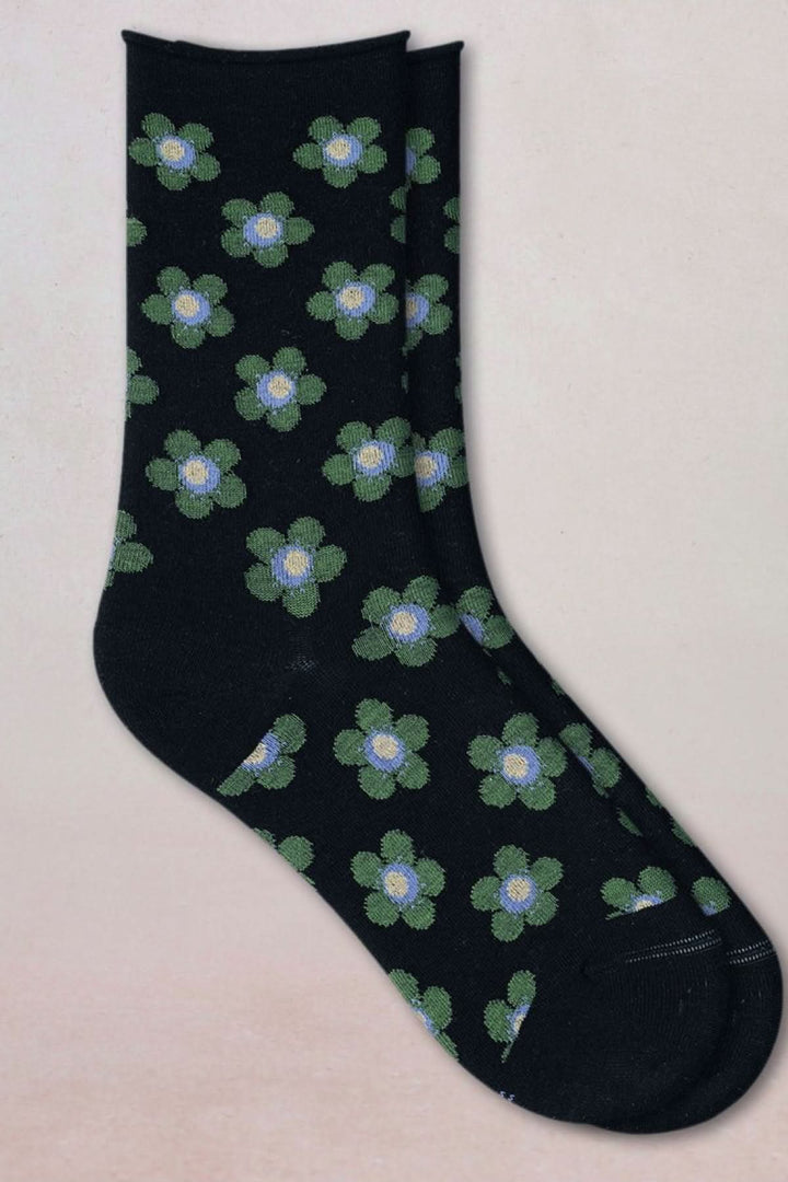Chaussettes en maille à petit motif floral avec fleurs vertes sur fond noir, longueur mi-mollet, bord-côte extensible en laine et coton.
