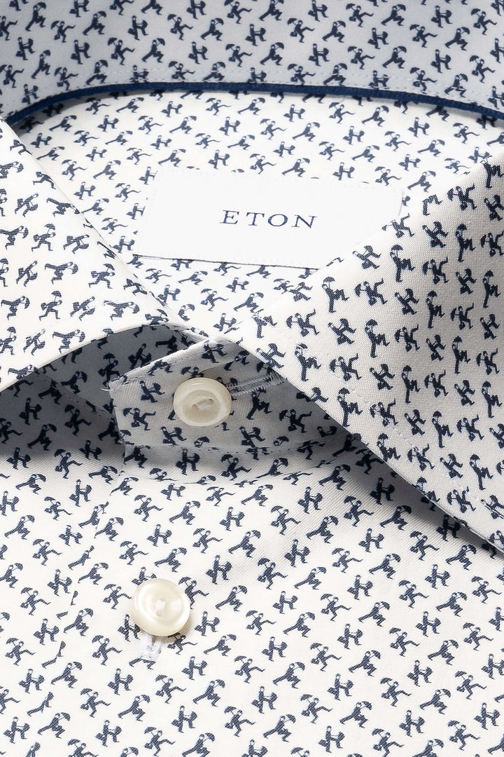 Chemise imprimé original avec de petites silhouettes en mouvement sur tissu raffiné, idéal pour tenues formelles.