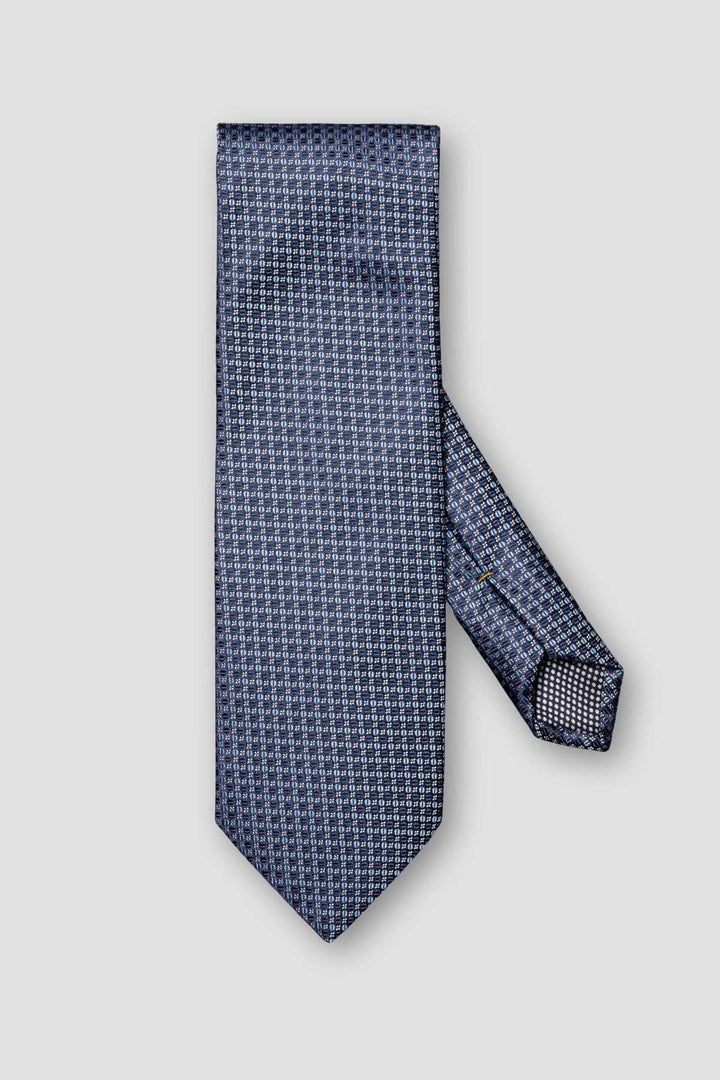 Cravate en soie bleu marine avec motif circulaire élégant, parfaite pour les occasions formelles.