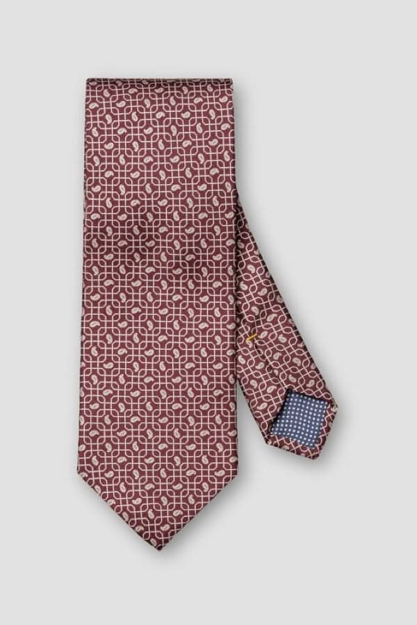 Cravate à motif géométrique en soie italienne avec doublure contrastante et finition lustrée, idéale pour des occasions élégantes.