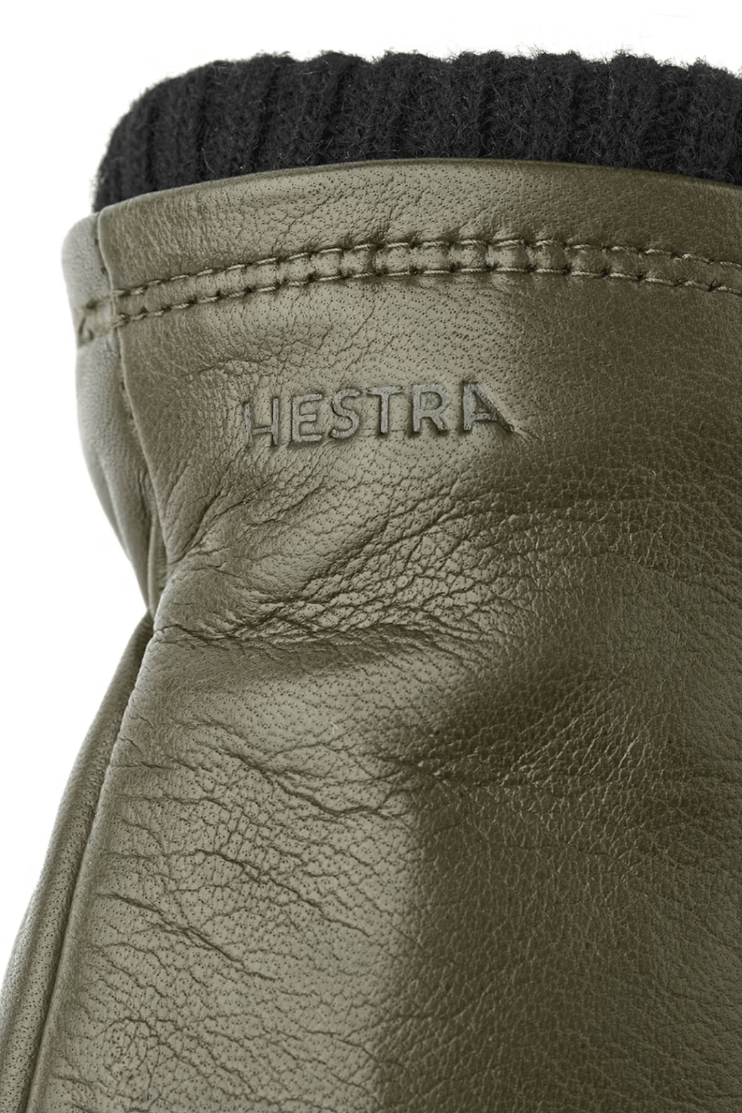 Gants de cuir avec logo Hestra et poignets en laine côtelée, idéal pour l'hiver et les sorties en nature.