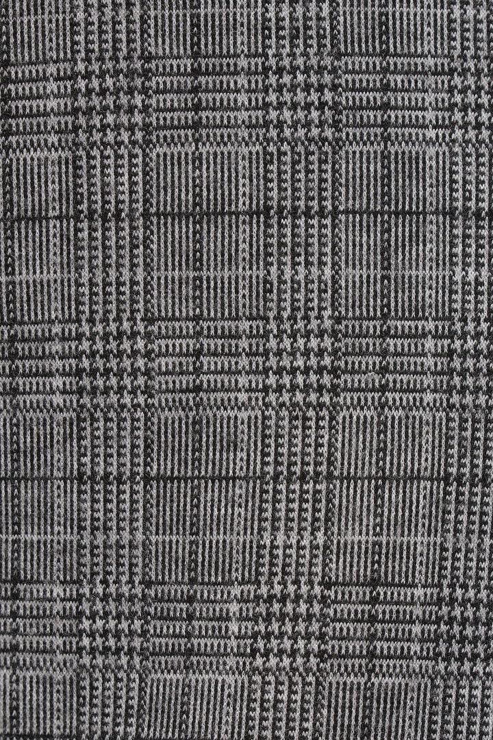 Motif à carreaux prince-de-galles en noir et gris pour pantalon élégant et intemporel.