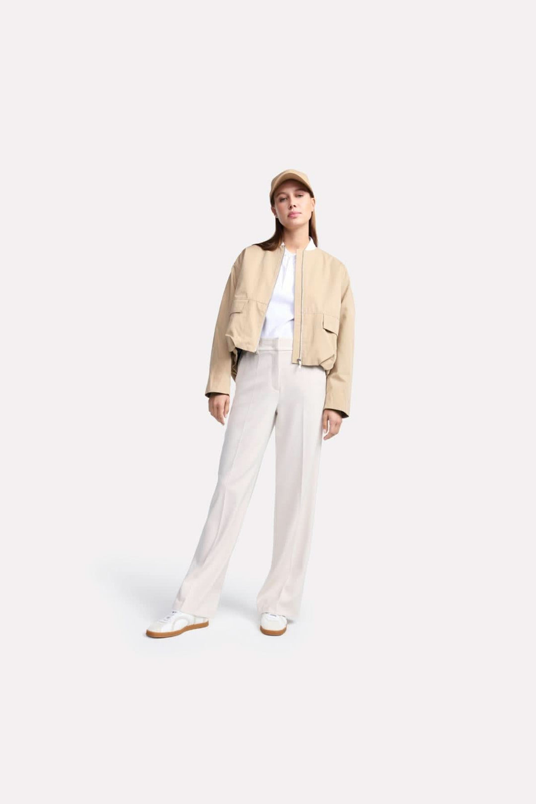 Modèle portant un pantalon classique Amelie à jambe large, associé à une veste beige et des chaussures blanches.