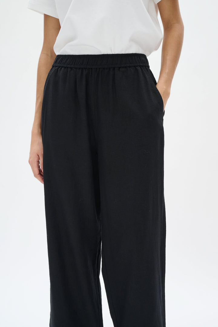 Pantalon en lin Rimona Driza, noir, taille élastique, jambes larges, poches latérales, style élégant et confortable.