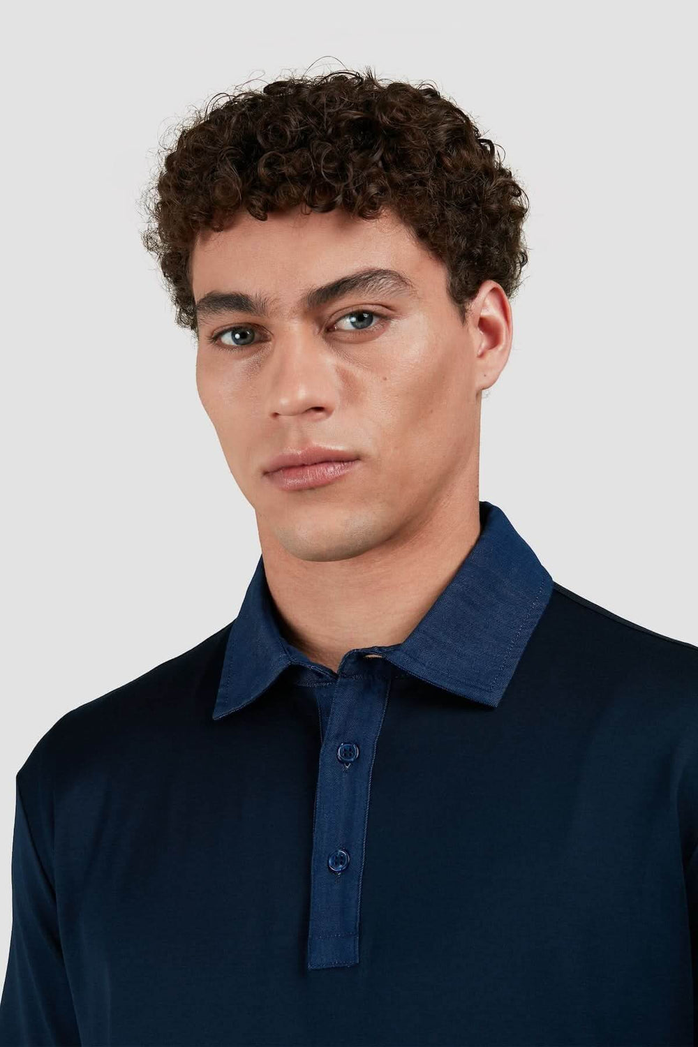 Polo marine en coton avec col en denim contrastant, offrant un look élégant et décontracté.