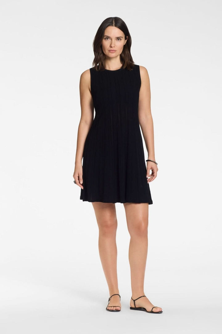 Femme portant une robe courte en maille texturée sans manches avec coupe ajustée et encolure ronde, idéale pour un look moderne et épuré.
