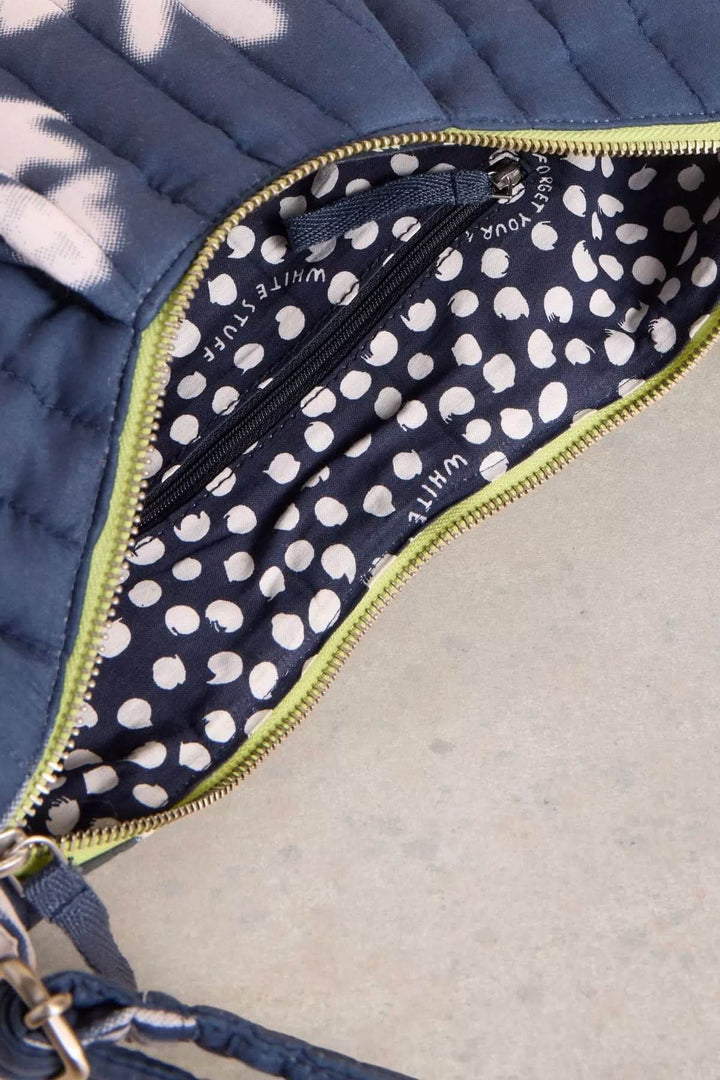 Intérieur du sac bandoulière Zoe avec motif pois sur fond bleu et fermeture à glissière.