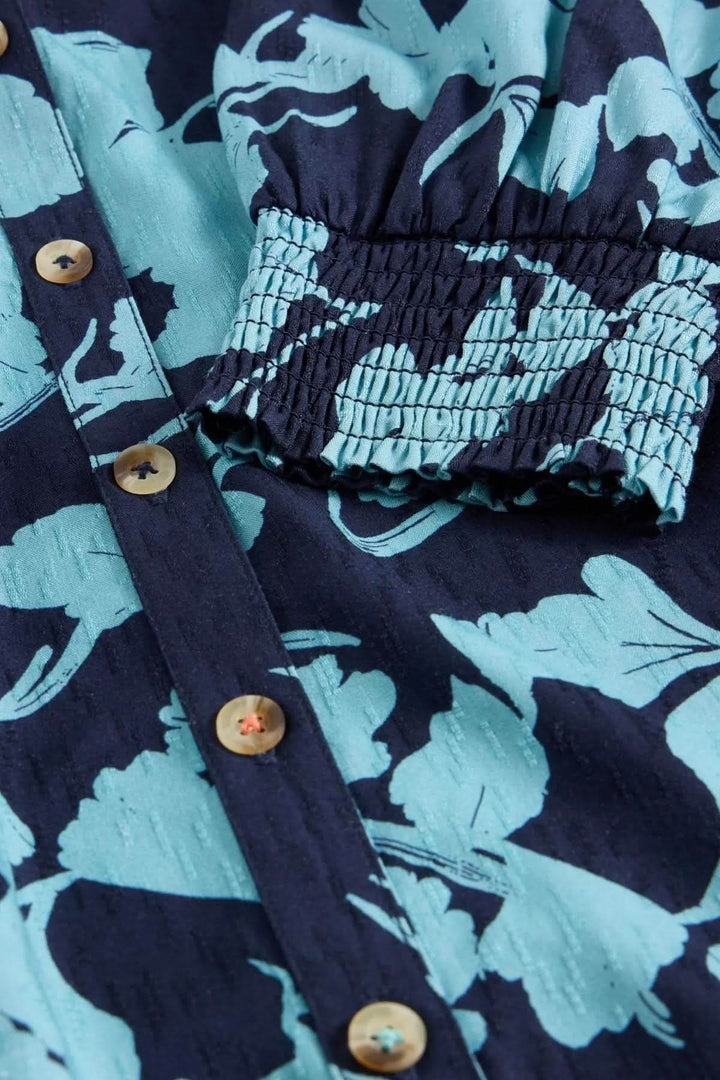 Détail de la tunique Amy avec imprimé botanique et coutures élégantes sur les manches.