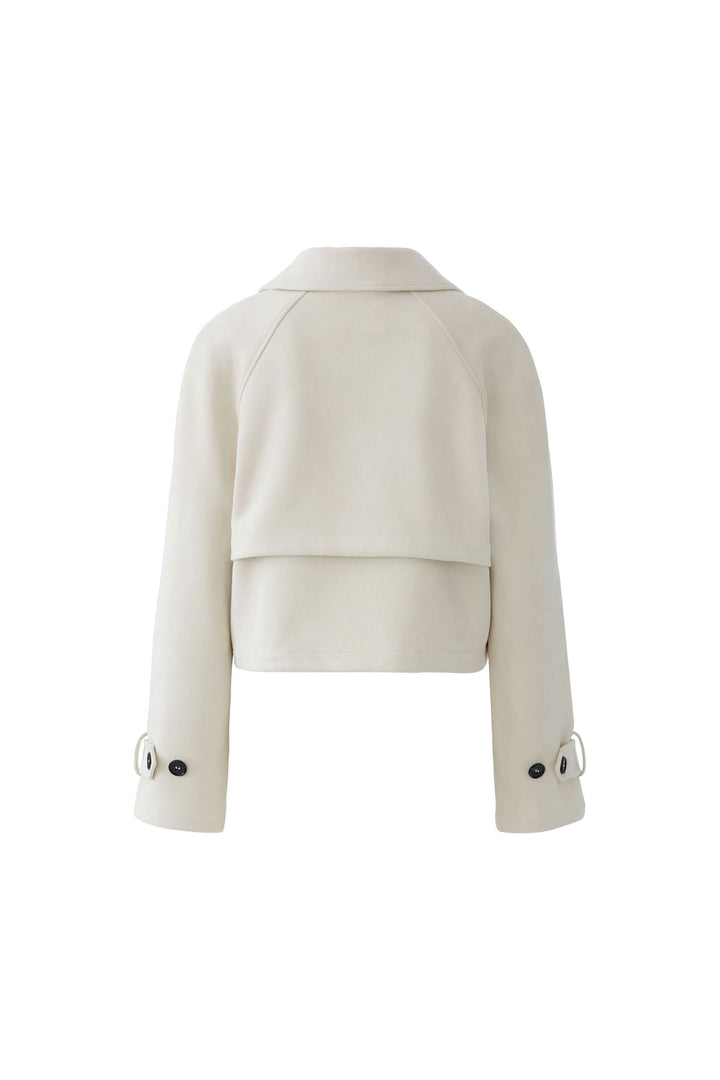 Veste courte croisée à col tailleur vue arrière en beige, design élégant et moderne pour une silhouette raffinée.