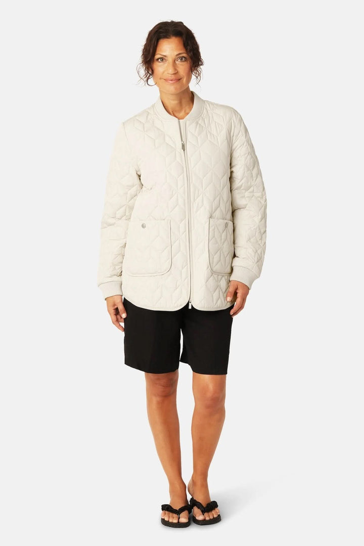 Veste matelassée mi-longue à fermeture éclair avec piquage géométrique, coupe droite et poches plaquées pour la mi-saison.
