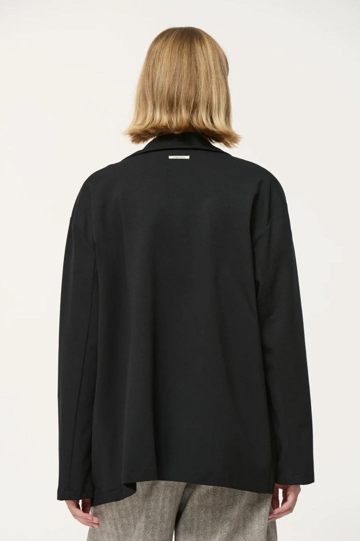 Veston Cayden noir, coupe droite et ample, vu de dos avec manches longues et emmanchures descendues.