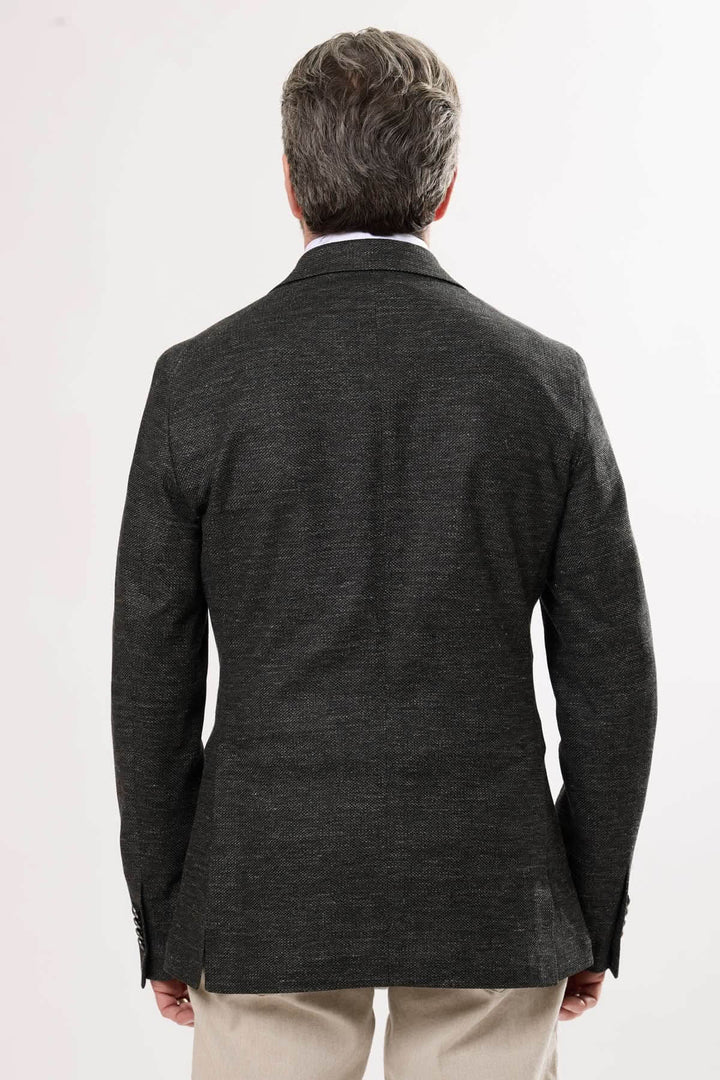 Veston en matière chinée noir vu de dos, alliant élégance sobre et style moderne.