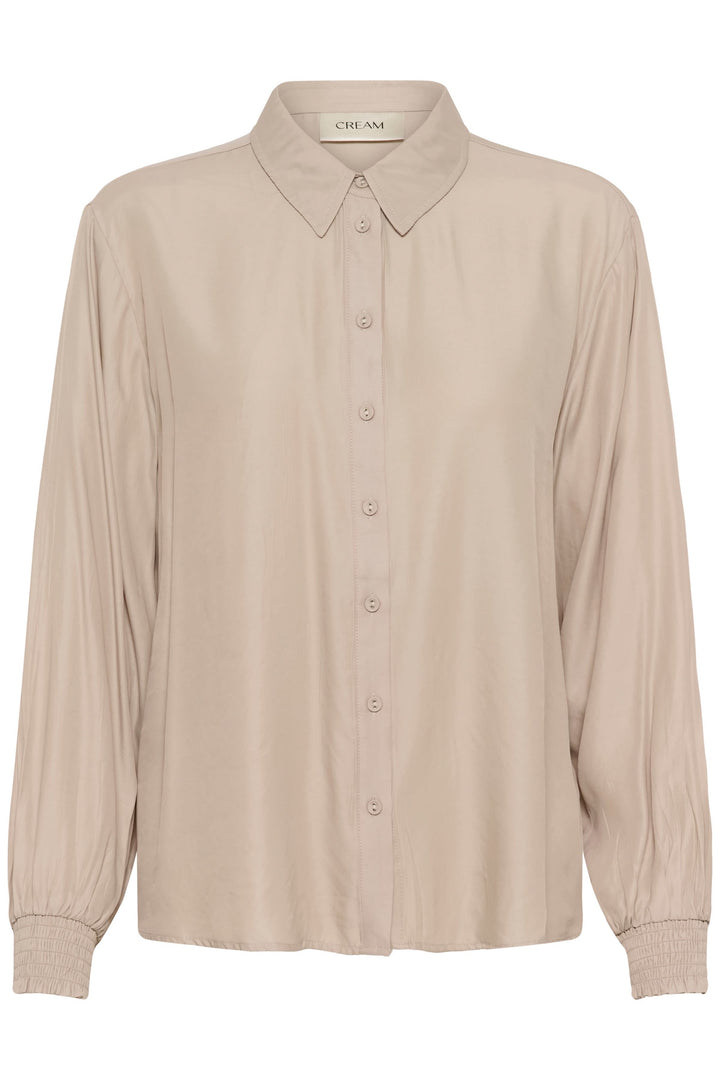 Blouse Nola fluide à poignets smockés, élégante et intemporelle, adaptée pour le travail ou le week-end, avec patte de boutonnage classique.