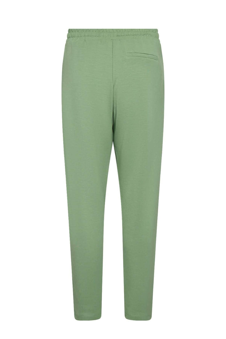 Pantalon jogging confortable vert, coupe ample, taille réglable, adapté pour un look homewear.