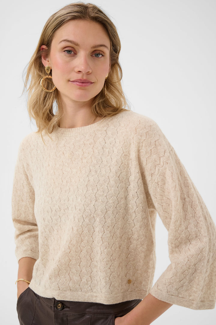 Front view of women’s blue sweater Cream with flared sleeves and openwork pattern - Valérie Simon