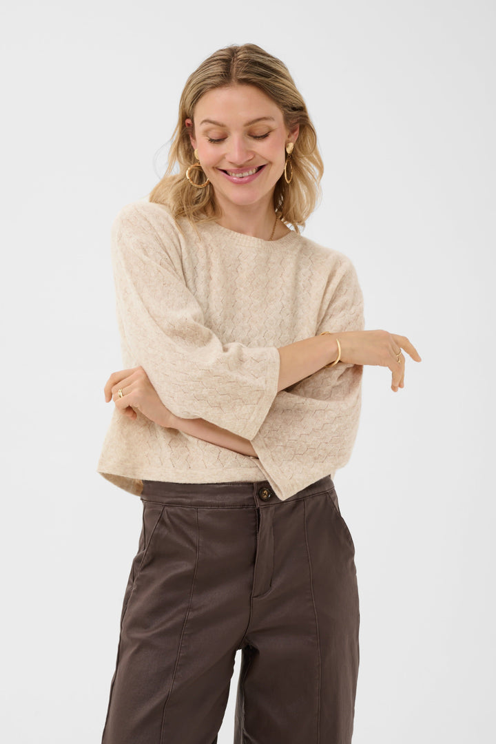 Model wearing women’s beige sweater Cream with openwork flared sleeves - Valérie Simon