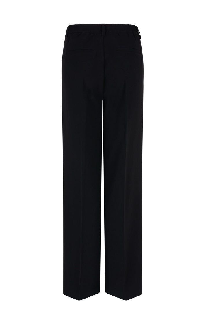 Pantalon habillé à jambe large, taille haute et plis marqués, vu de dos, élégant et moderne.