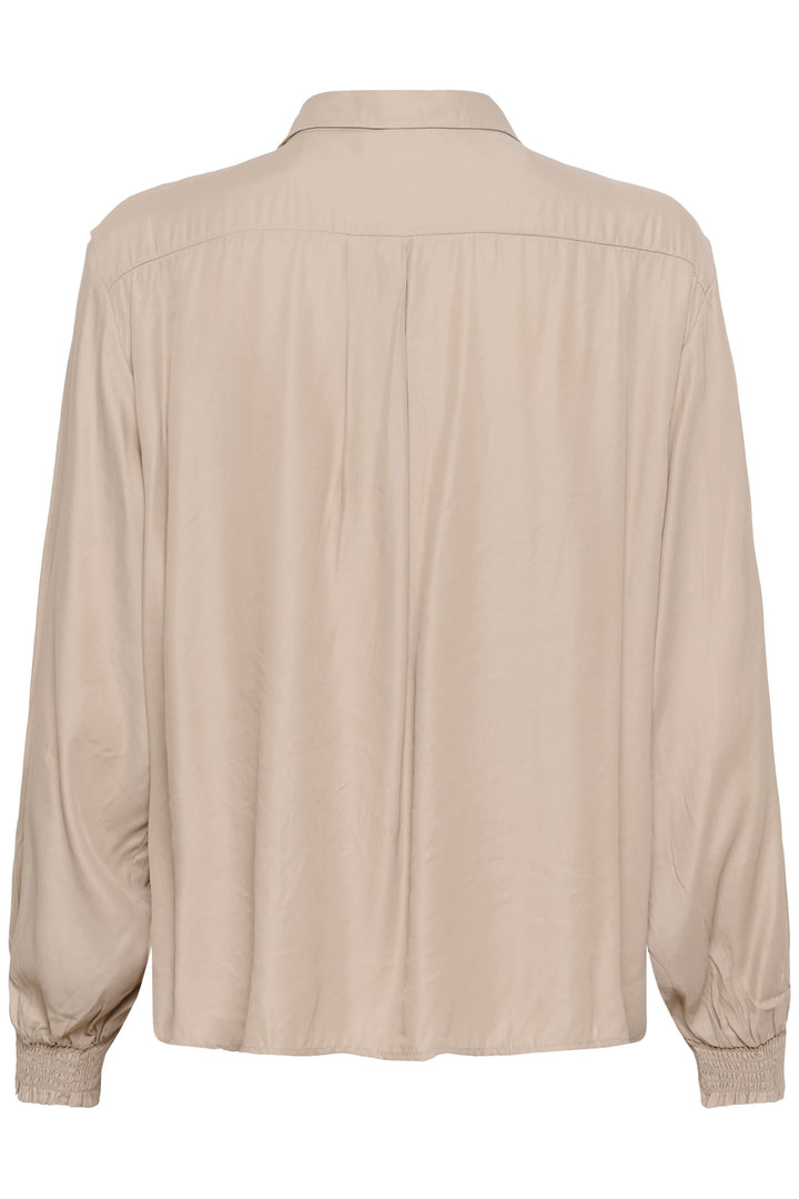 Blouse Nola fluide à poignets smockés beige vue arrière élégante et confortable, décris moi le produit en français.