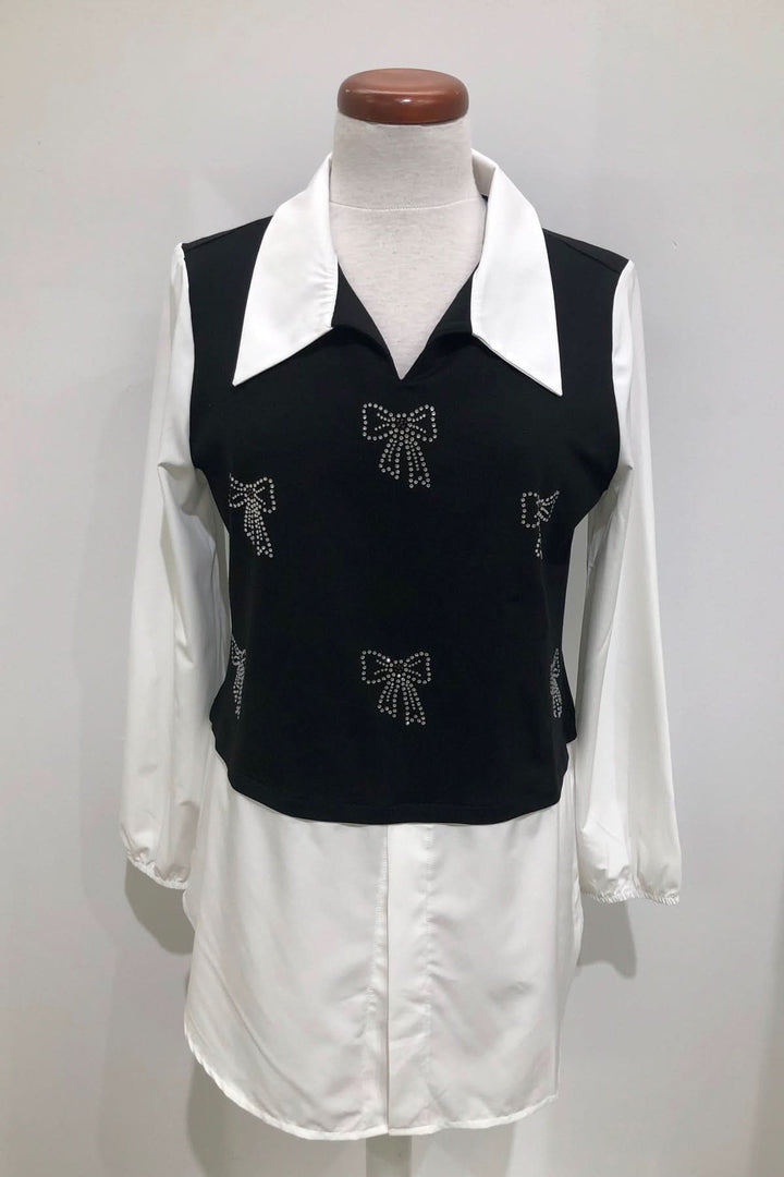 Tunique bicolore élégante avec nœuds strass, col chemise blanc et manches bouffantes, parfaite pour un look de bureau stylé.