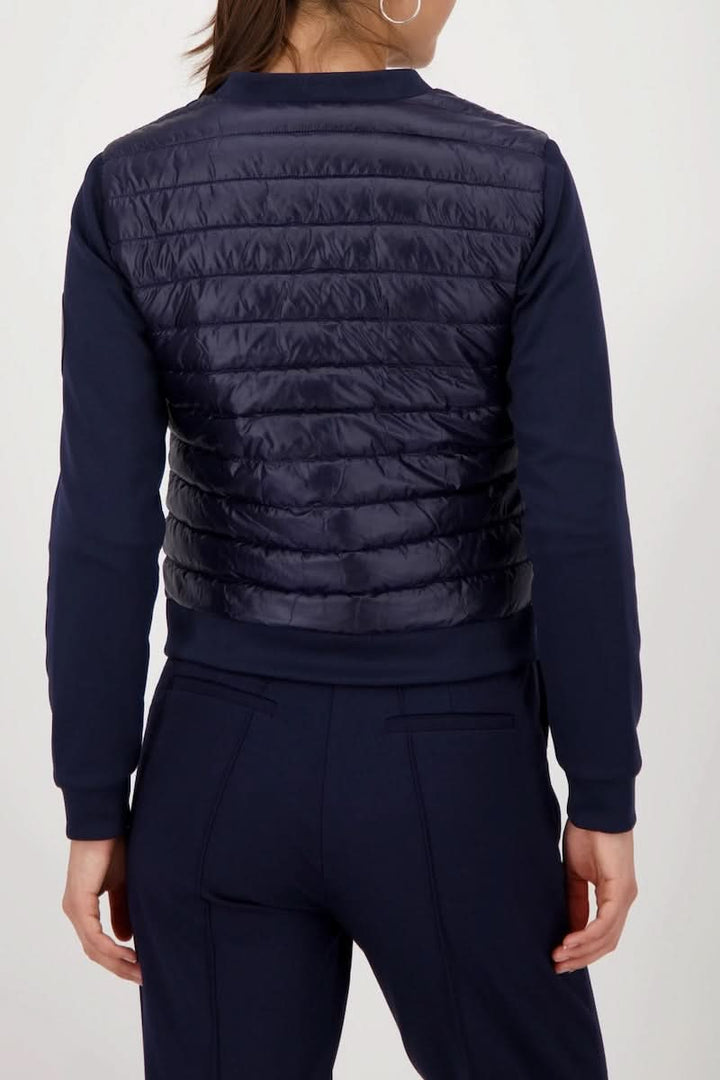 Alt Tag: Veste matelassée bimatière à fermeture éclair pour femme, vue de dos, combinaison de style sportif et confort.