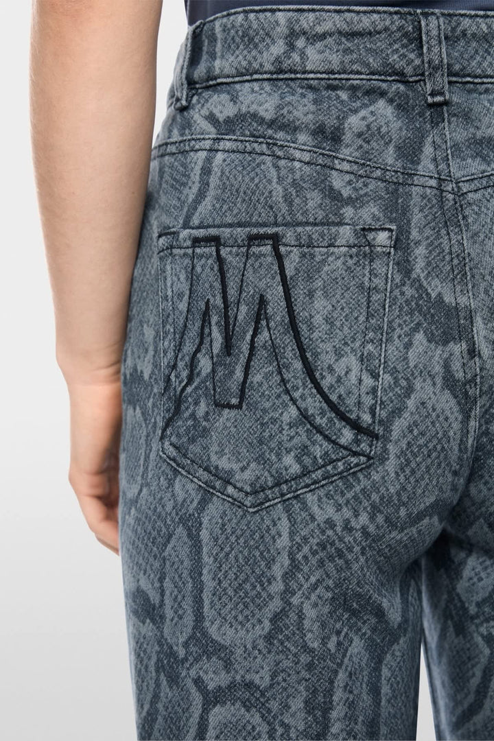 Side view of Marc Cain blue jeans with distressed details for women - Valérie Simon