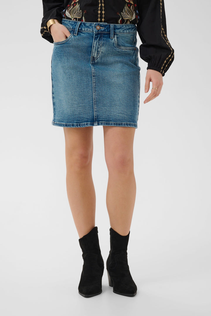 Side view of a short blue denim skirt Cream for women with visible topstitching - Valérie Simon