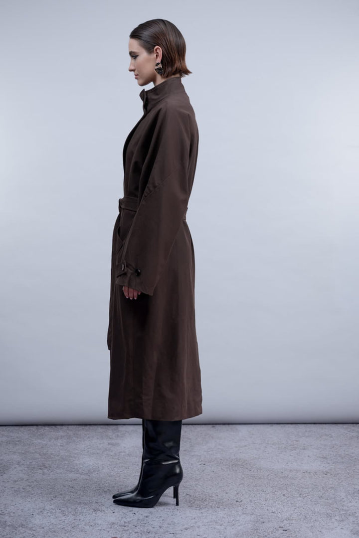 Front view of the Haako belted coat for women in beige with pockets and a silver button - Valérie Simon