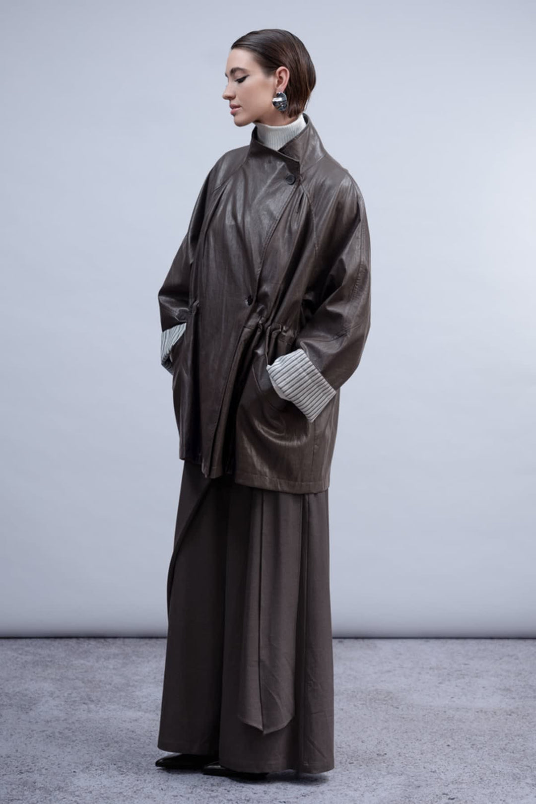 Front view of the Haako black faux leather coat for women with a wide collar - Valérie Simon