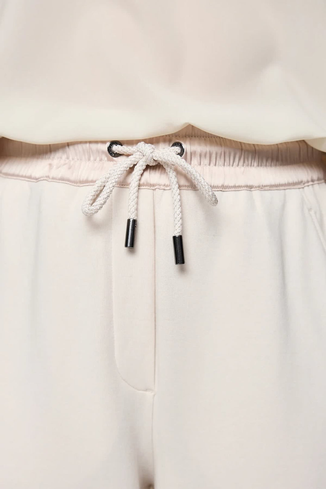 Casual pants with black satin stripes, front view, close-up details - Marc Cain for women - Valérie Simon