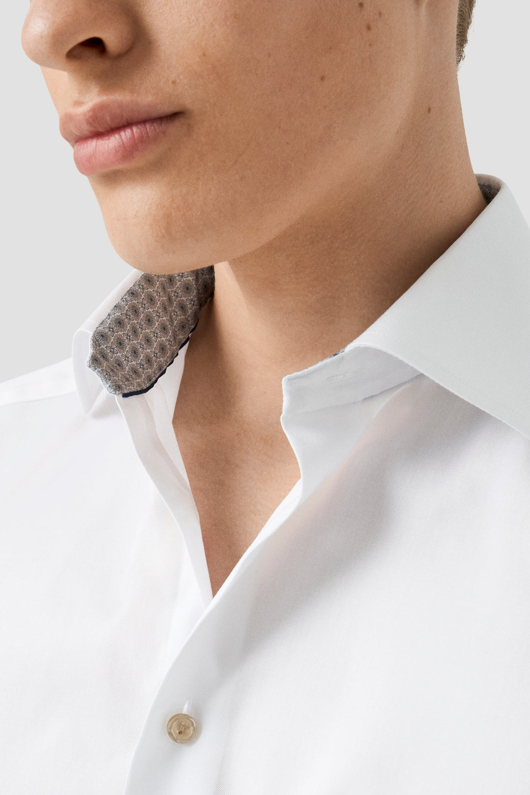 Chemise habillée blanche avec col italien et imprimé discret, idéale pour occasions professionnelles.