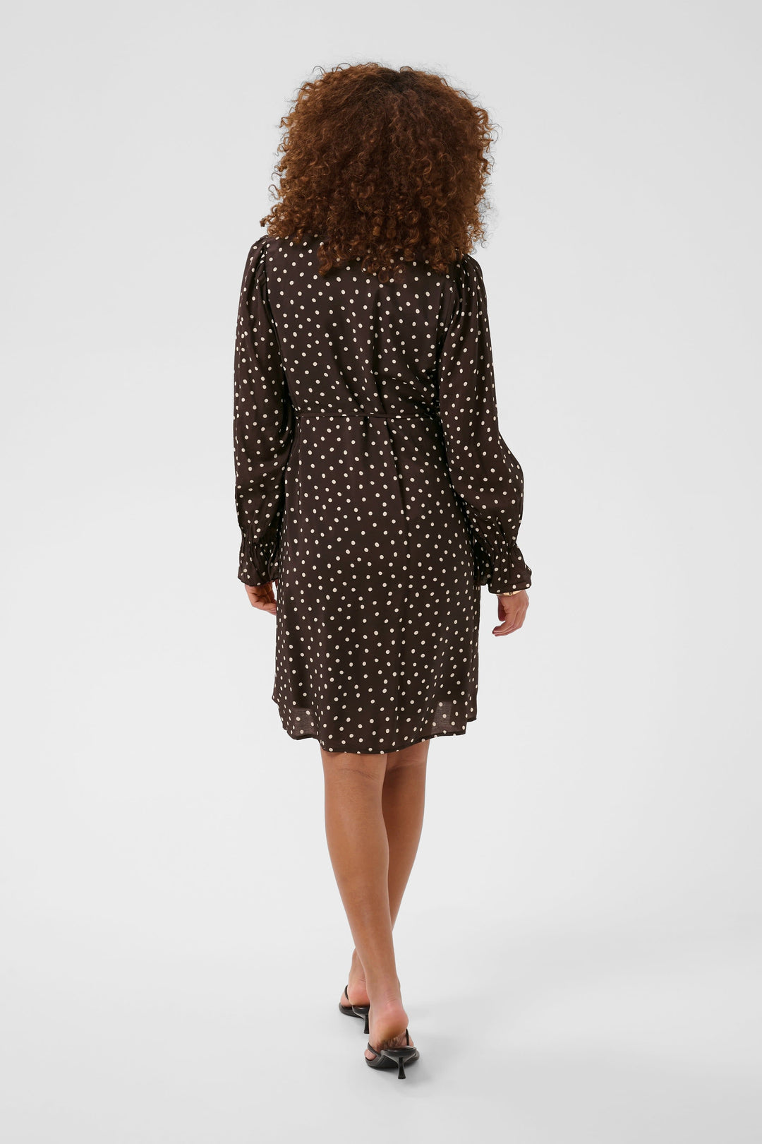 Side view of a short black polka-dot dress for women by Kaffe - Valérie Simon
