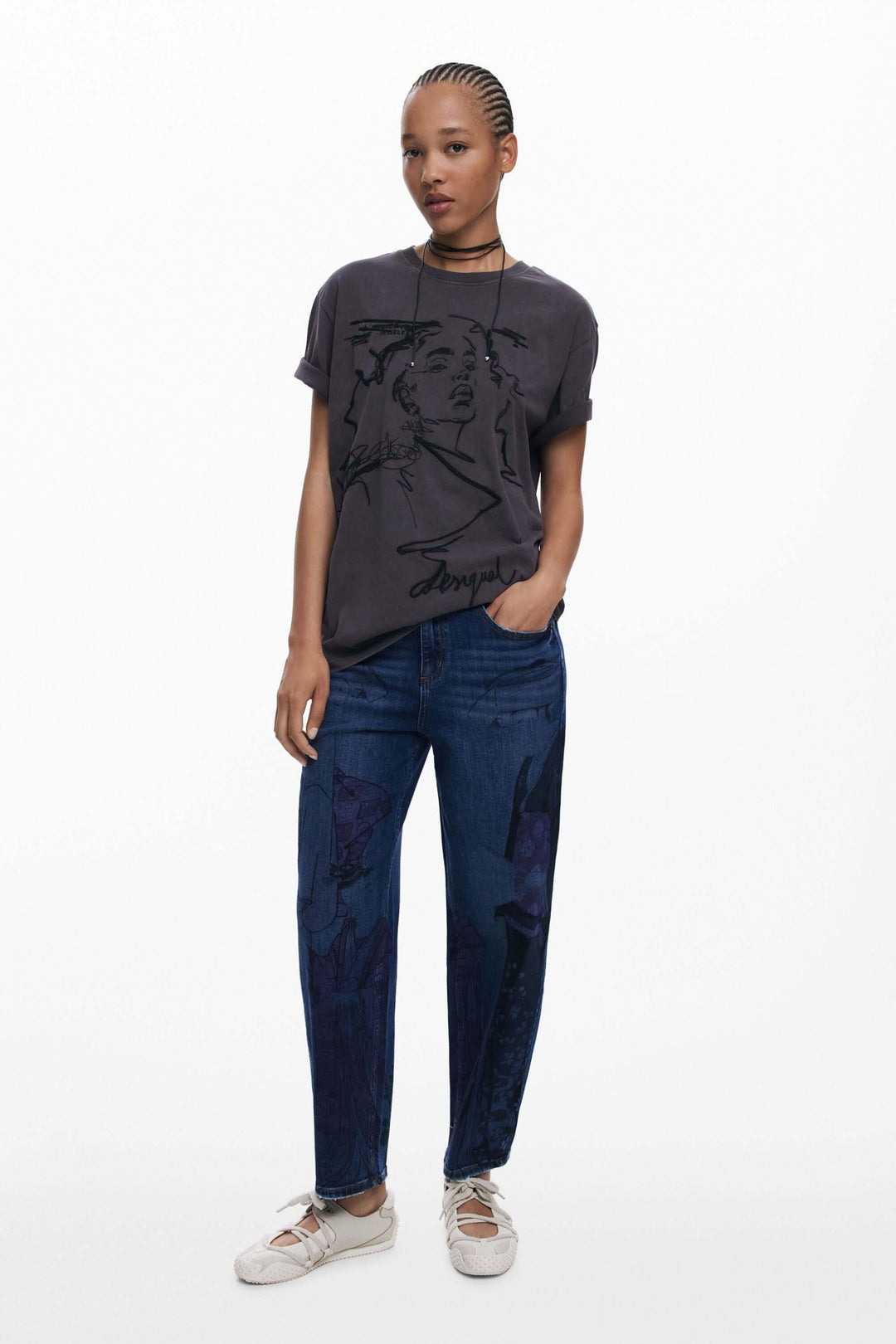 T-shirt à manches courtes avec imprimé artistique, porté avec un jean décontracté et des baskets.