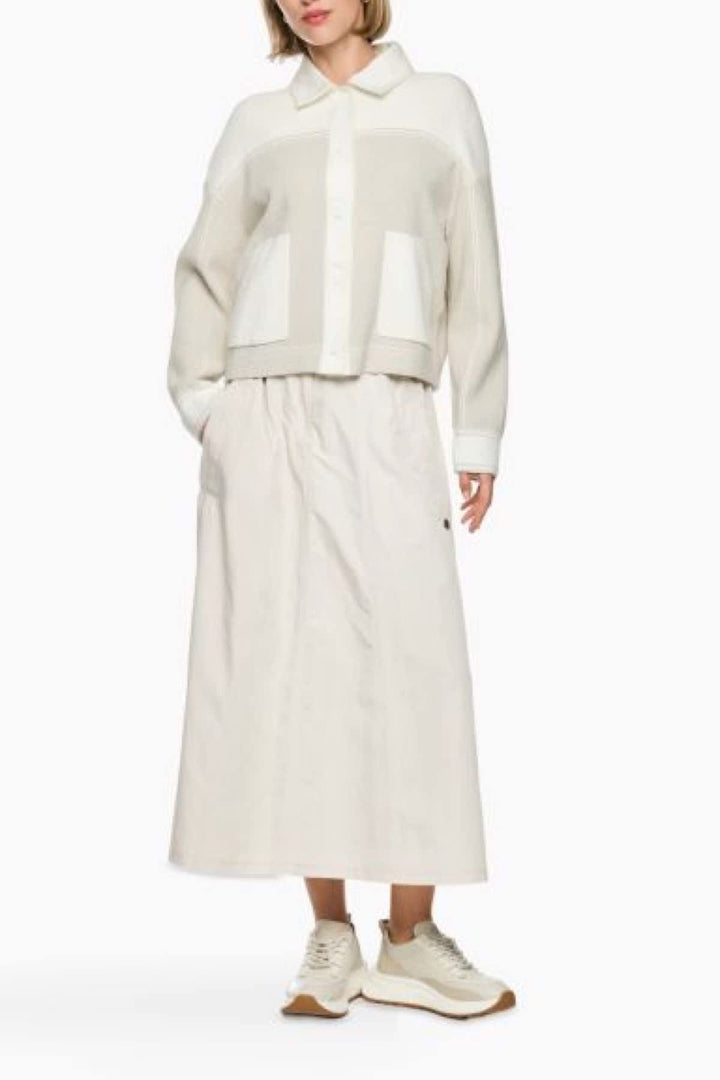 Side view of a beige textured knit overshirt by Marc Cain for women, featuring button details - Valérie Simon