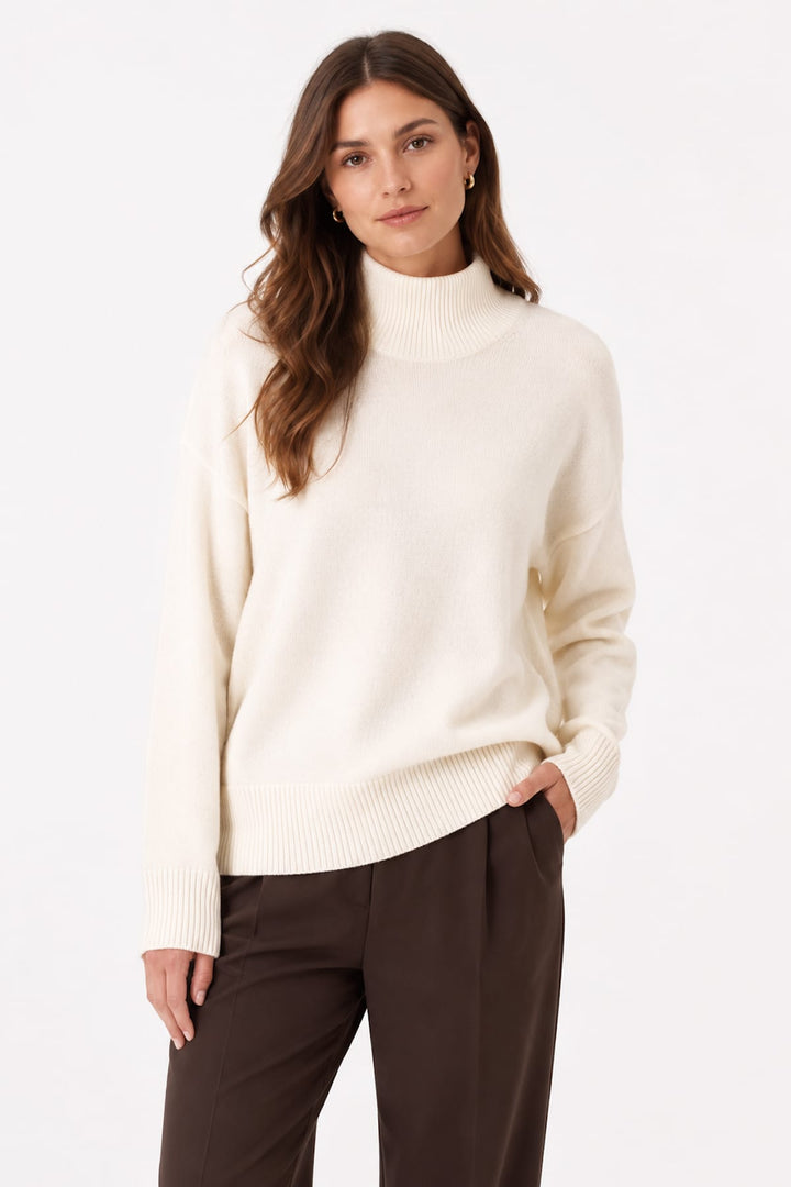 Side view of a gray knit turtleneck Repeat Cashmere for women, with wide sleeves - Valérie Simon