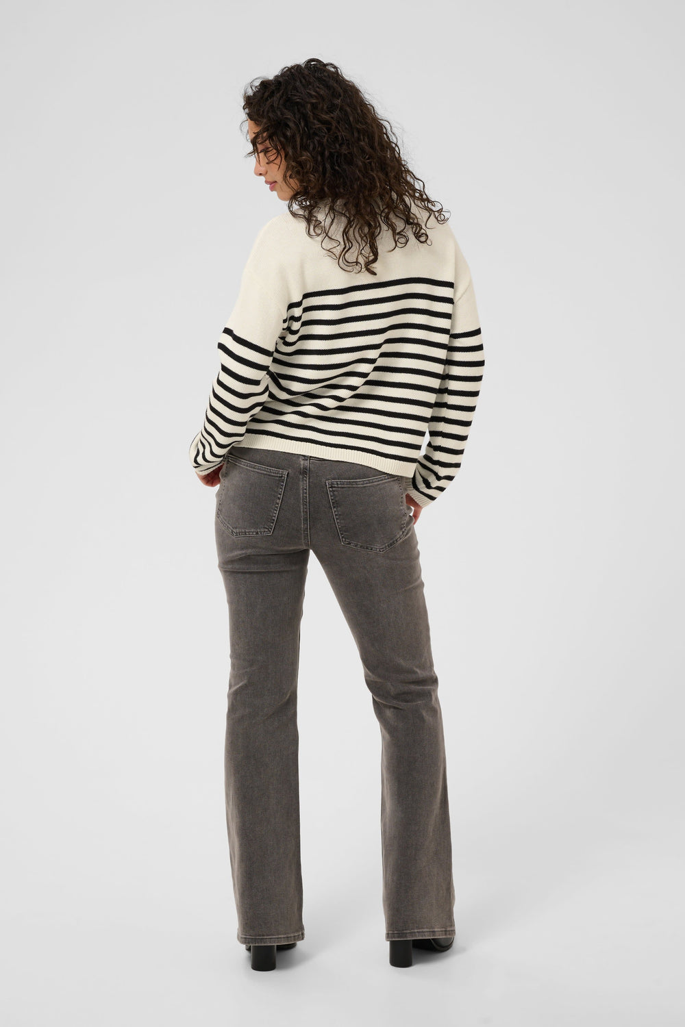 Front view of a striped knit top with "Kaffe" lettering for women in white and black - Valérie Simon