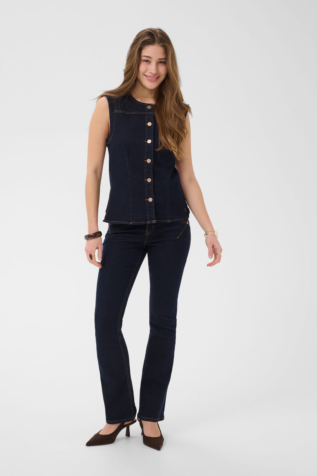Side view of a blue denim sleeveless jacket Cream for women with metal buttons - Valérie Simon