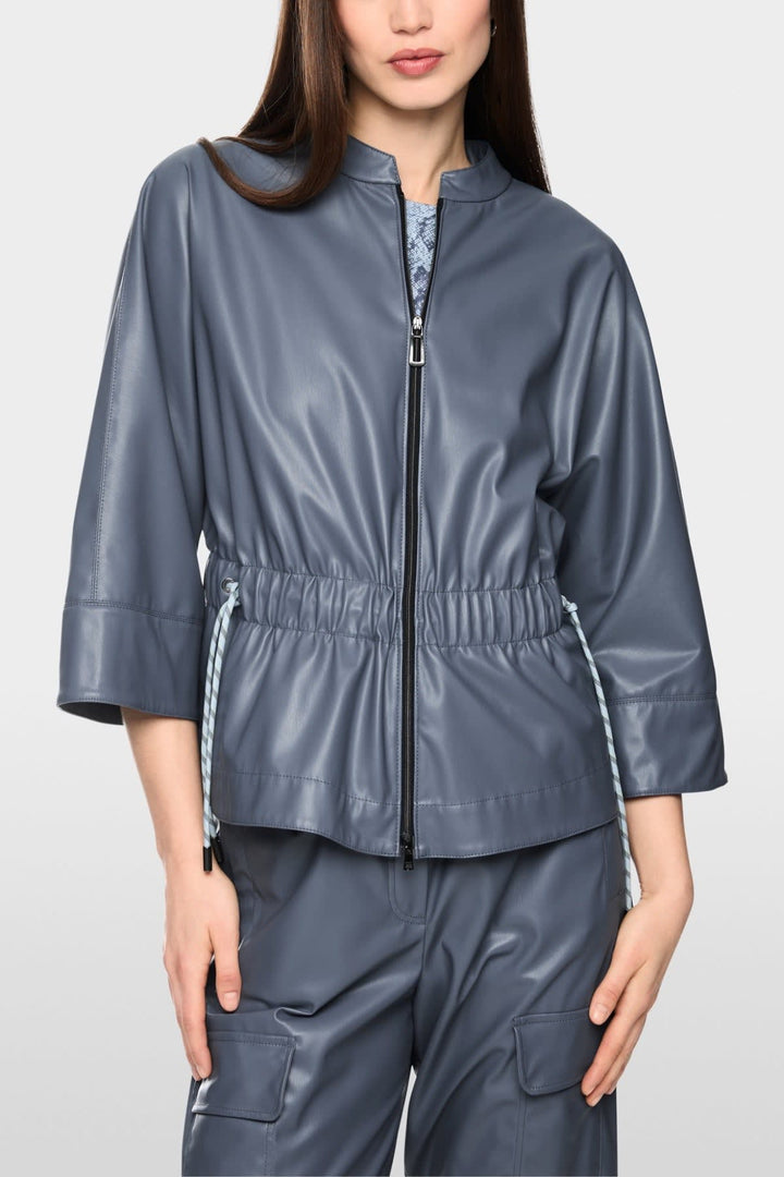 Side view of a brown Marc Cain faux leather jacket with a lapel collar and zippered pockets for women - Valérie Simon
