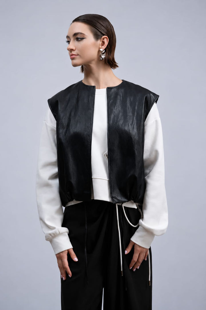 Front view of Haako black faux leather sleeveless button-front jacket for women - Valérie Simon