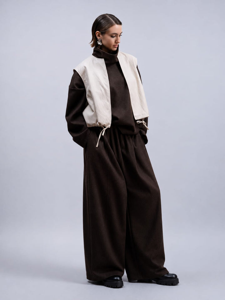 Side view of the Haako black faux leather sleeveless jacket for women - Valérie Simon