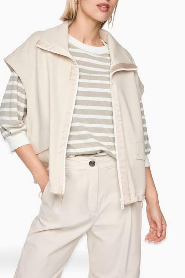 Side view of a blue Marc Cain sleeveless jacket with a high collar - Valérie Simon
