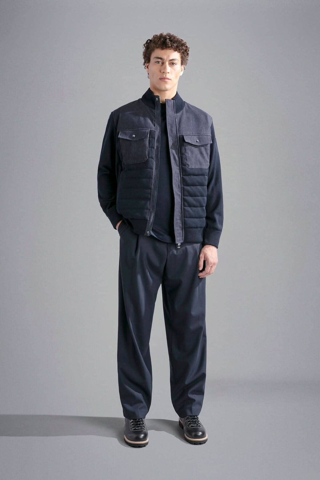 Homme portant une veste d'extérieur matelassée Paul & Shark, style moderne et confortable, avec pantalons assortis.